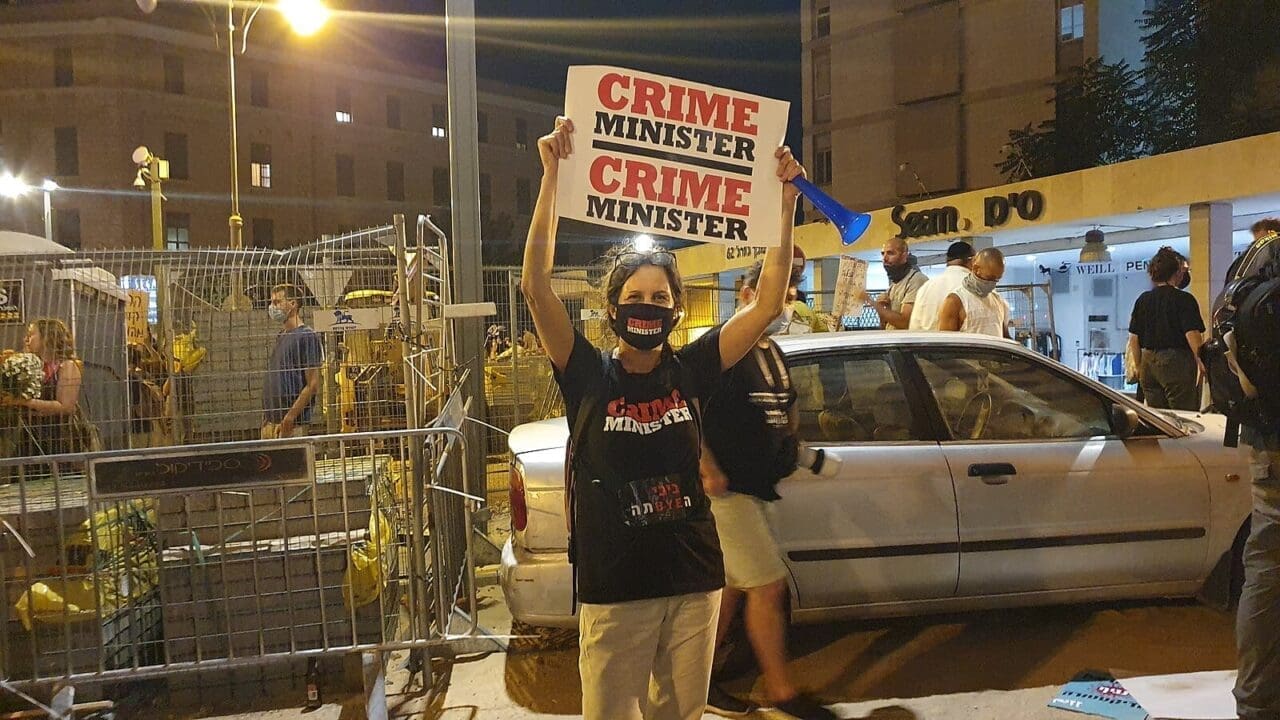 International Criminal Court prosecution of Netanyahu:A protester holds a sign that says CRIME MINISTER during 2020 protests against Netanyahu.