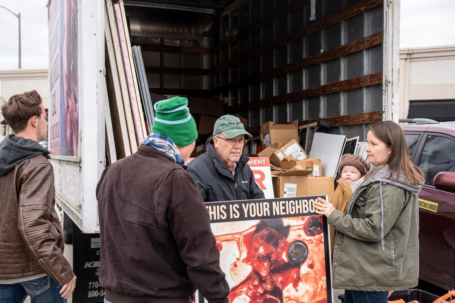 Matthew Trewhella unloading abortion signs