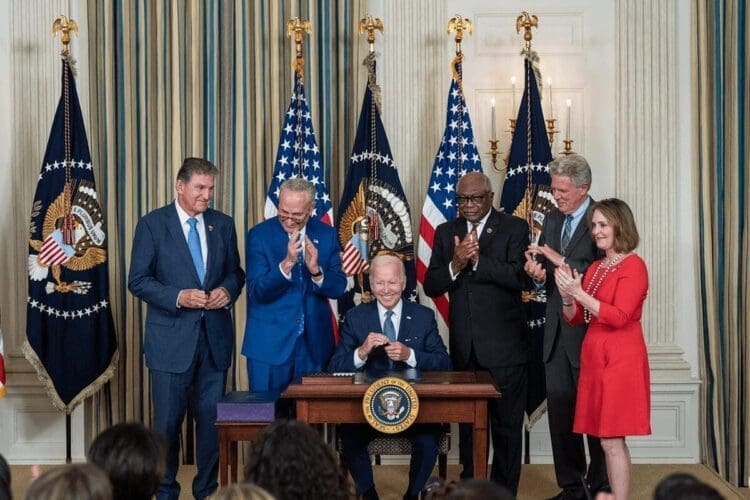 Democrats around President Biden as he signed the infrastructure bill with climate provisions