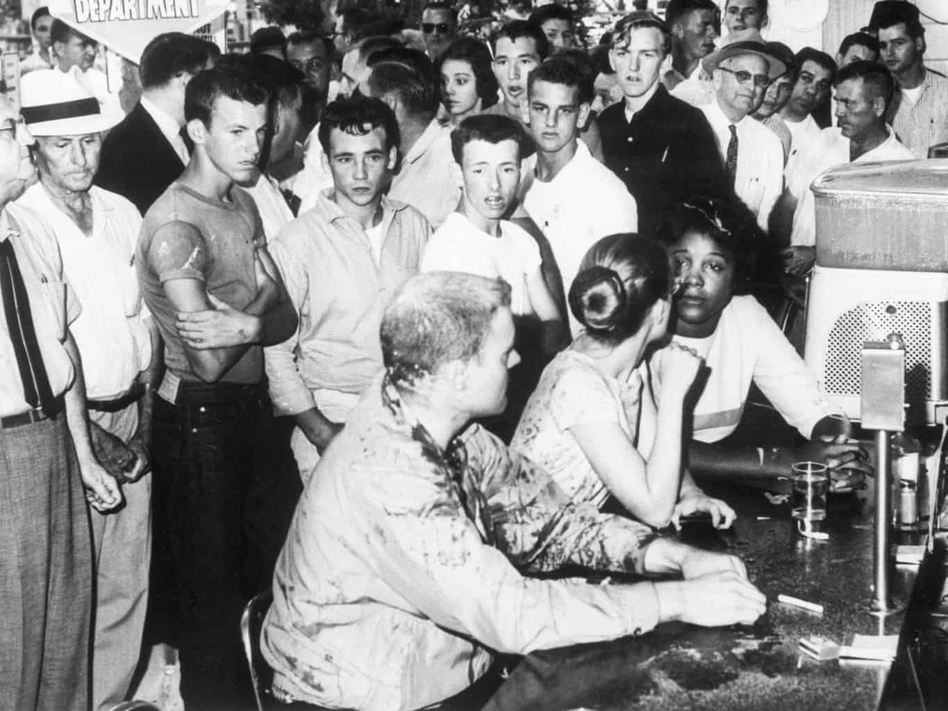 To Serve Or Not To Serve: Should Business Owners Deny Service Based On Religious Beliefs? Black women being intimidated by white men in a “white’s only” restaurant.