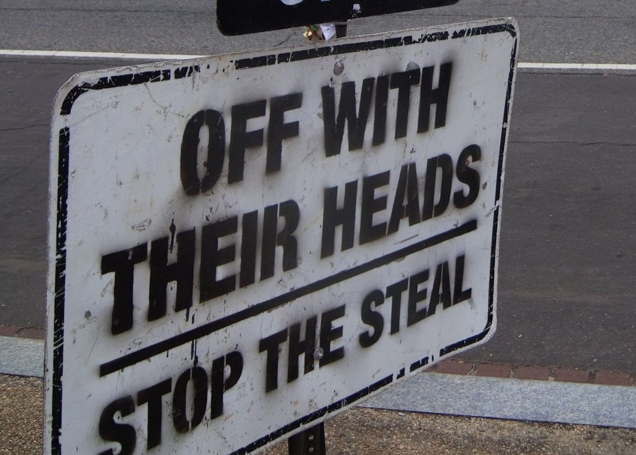 When will we know 2024 election results A sign that says, “OFF WITH THEIR HEADS, STOP THE STEAL”