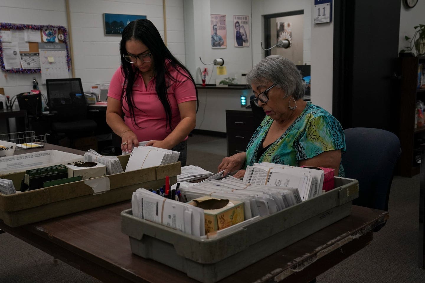 A clerk looks through Texas paper registration forms