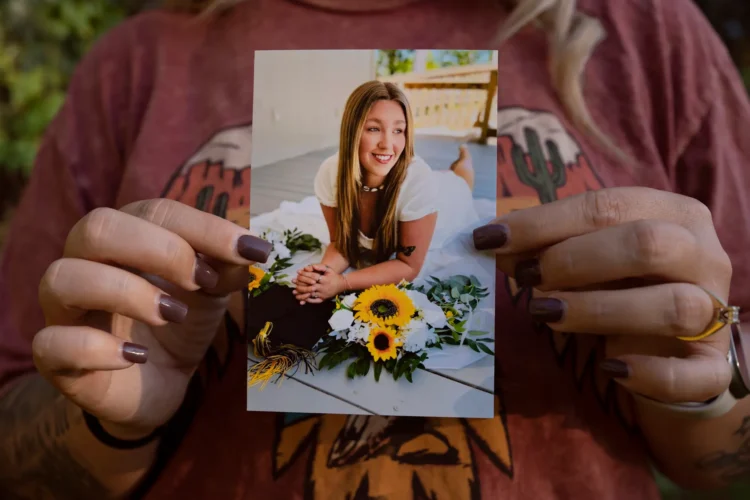 Mother holds photo of 18-year-old daughter who died in Texas