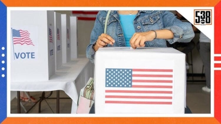 A woman putting a ballot in a ballot box with an American flag on the front